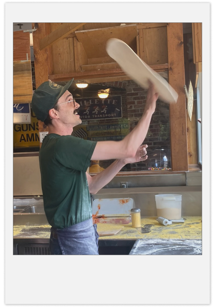 Spinning pizza dough in the air.