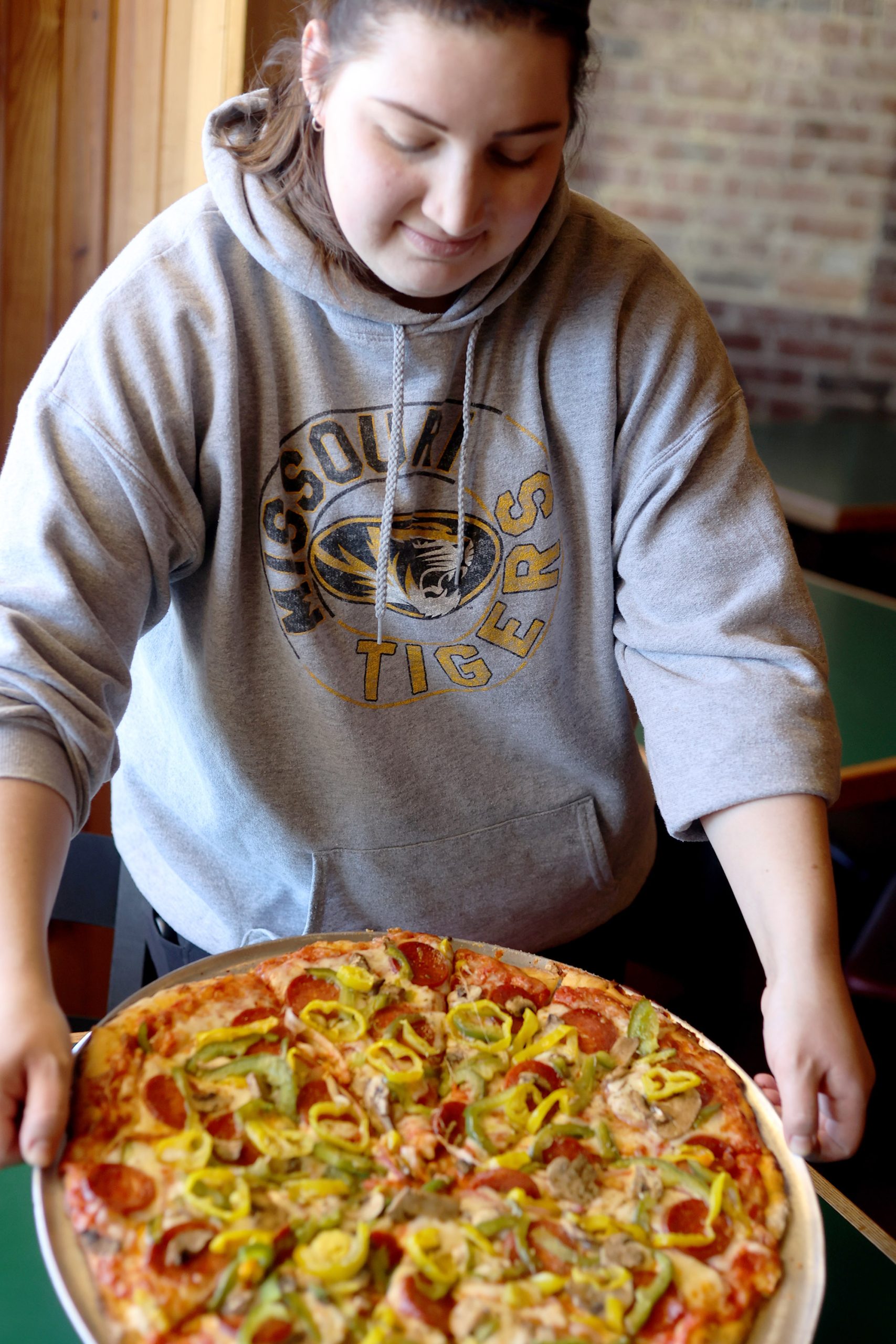 Serving pizza