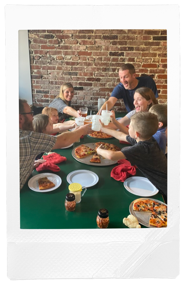 Family cheersing over pizza